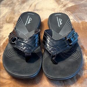 Clarks Cloud-steppers in black with patent strap.